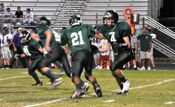 Conner Ricker hands the ball off to Colin Baker during the Boerne game.