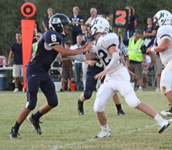 Defensive End Peter Corey keeps the play in front of him as he sizes up their quarterback