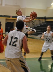 Tyler Clark drives for the basket as Andrew Riali looks on