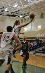 Robbie Ferris goes in for a lay up as Andrew Riali waits for the result