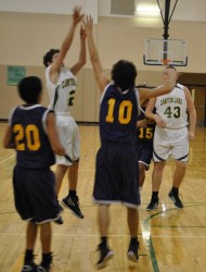 Garrett Winters soars for two points as Sean Nolan waits for a rebound if needed.