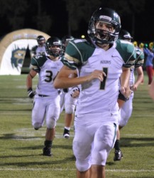 Mike Thorpe leading Hawk team on the field. Thorpe was a pleasant surprise kicking for Canyon Lake.