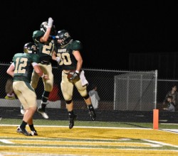 Celebrating another Touchdown as Skyler Tschoepe and Hayden DuBois greet McGuire Johnson