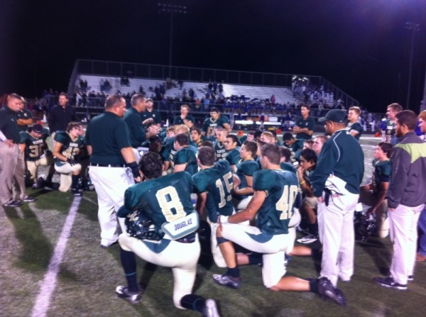 Head Coach Charlie Drum talking to joyous players after Boerne game.