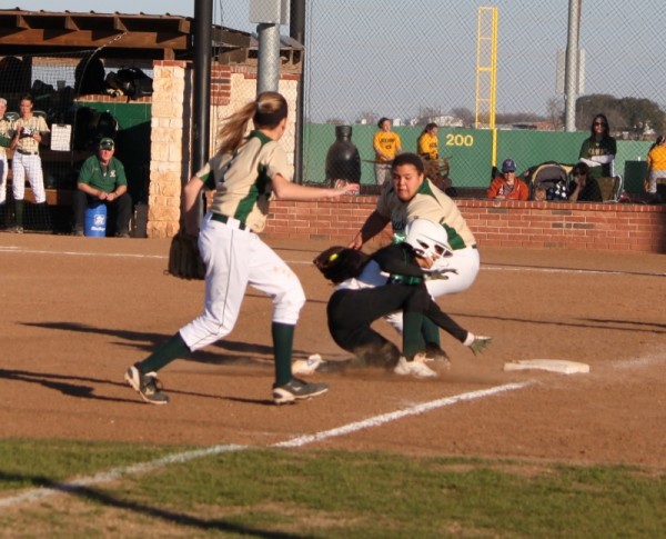 Hawks Kelsey Ahrens puts the tag on player while Kat Weber comes in for reinforcements.