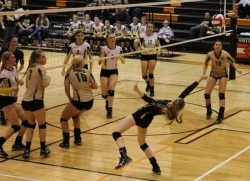 Libero Hayley Melone doing the Limbo while playing Volleyball