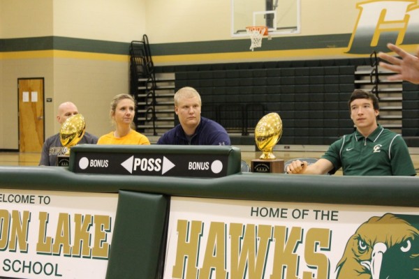 Waiting to sign as Coach Drum gives the audience accolades of Football and Classroom Victories these two players exemplified