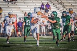 Ethan Slater does not let a face mask stop him from getting the tackle