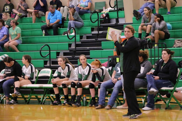 Head JV Coach Megan Helmey giving serving instructions to a Hawk Server