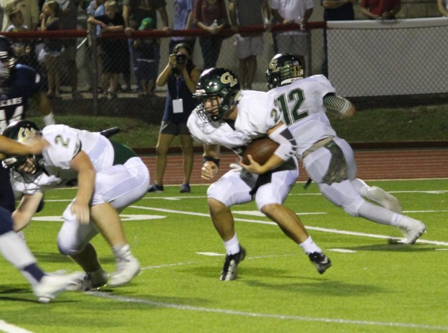 Austin Brennan looks for hole as Micah St. John blocks a Texan